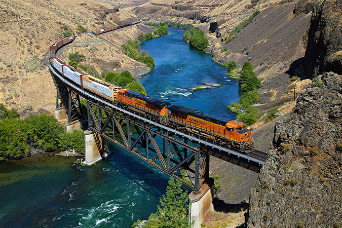 A merchandise train crosses the scenic Deschutes River Canyon at Sherars Falls, Oregon. A merchandise train crosses the scenic Deschutes River Canyon at Sherars Falls, Oregon.